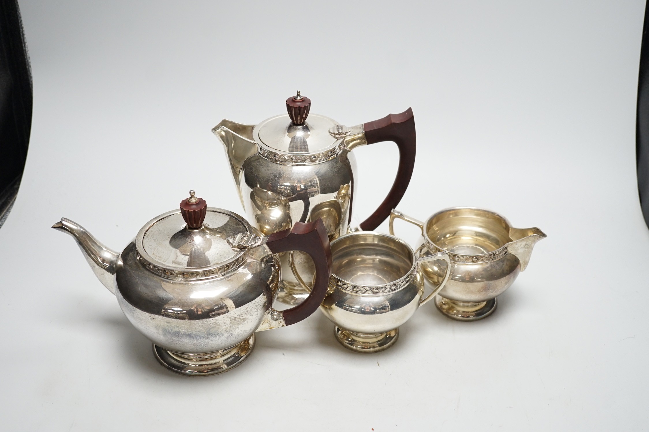 An Elizabeth II silver four piece tea set, with foliate border, A. E Jones Ltd, Birmingham, 1966, gross 65oz.